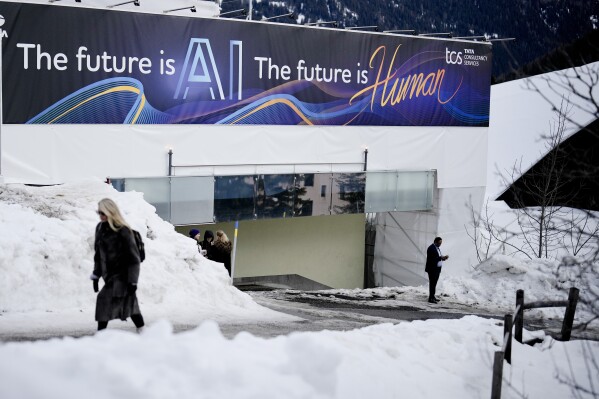 An advertising banner with a slogan about AI is fixed at a building at the Davos Promenade, alongside the World Economic Forum in Davos, Switzerland, Jan. 18, 2024. (AP Photo/Markus Schreiber, File)