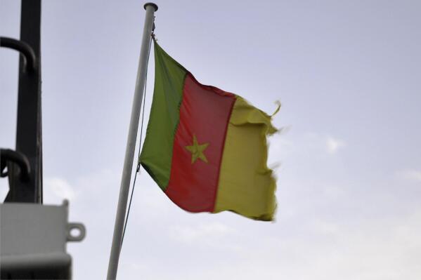 A Cameroonian flag flies on a ship at the port in Douala, Cameroon, on April 10, 2022. In recent years, the country has emerged as one of several go-to countries for the widely criticized “flags of convenience” system, under which companies can - for a fee - register their ships in a foreign country even though there is no link between the vessel and the nation whose flag it flies. (AP Photo/Grace Ekpu)