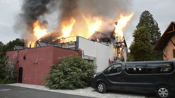 Fire rages at a vacation home in the town of Wintzenheim, north-eastern France, Wednesday Aug. 9, 2023. A fire ripped through a vacation home for adults with disabilities in eastern France on Wednesday, killing several people, the head of rescue operations said. (TNN/dpa via AP)