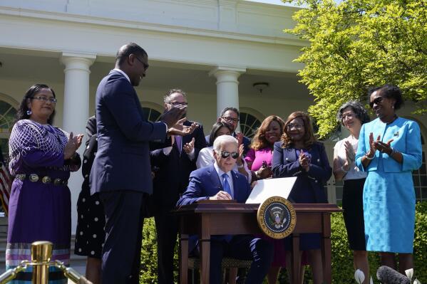 President Joe Biden signs an executive order that would create the White House Office of Environmental Justice in the Rose Garden of the White House in Washington, Friday, April 21, 2023.(AP Photo/Susan Walsh)