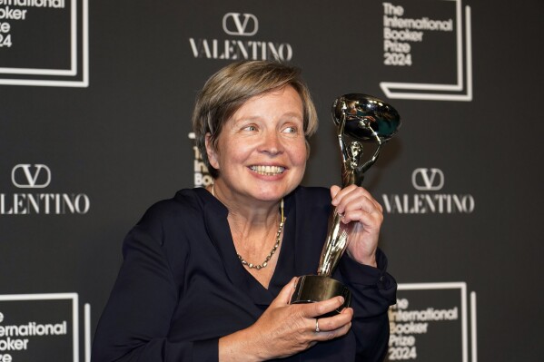 Jenny Erpenbeck, author of 'Kairos', holds the trophy after winning the International Booker Prize, in London, Tuesday, May 21, 2024. (AP Photo/Alberto Pezzali)