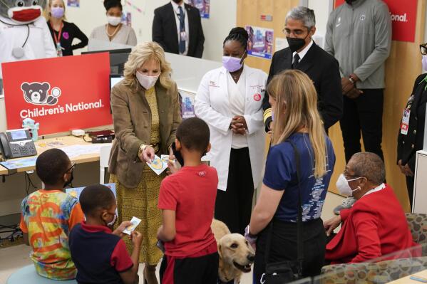 First lady Jill Biden hands out stickers to recently vaccinated children during a visit to a pediatric COVID-19 vaccination clinic at Children's National Hospital's THEARC, Wednesday, Nov. 17, 2021, in Washington. (AP Photo/Patrick Semansky)