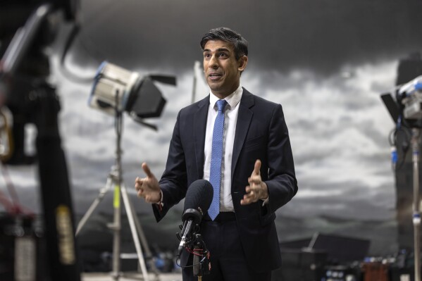 Britain's Prime Minister Rishi Sunak speaks during a TV interview in front of a painted back drop of a stormy sky which was created by students in a film studio at the National Film and Television school, in Beaconsfield, England, Monday, Jan. 22, 2024. (Richard Pohle, Pool Photo via AP)