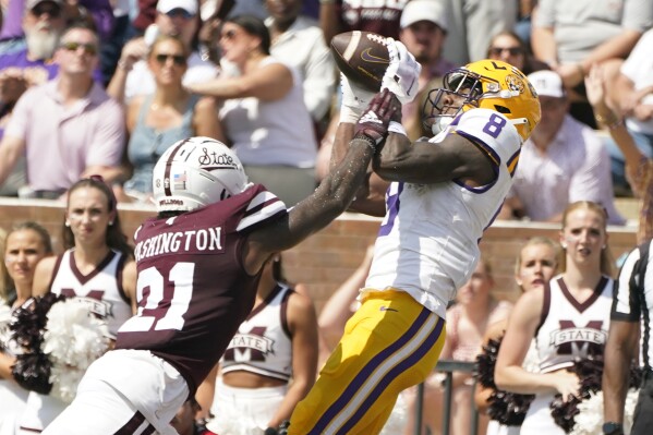 LSU wide receiver Malik Nabers (8) catches a 26-yard touchdown pass reception over the defense of Mississippi State safety Hunter Washington (21) during the first half of an NCAA college football game, Saturday, Sept. 16, 2023, in Starkville, Miss. (AP Photo/Rogelio V. Solis)