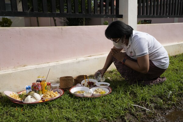 A relative of a victim prays in front of former childcare center after the Buddhist ceremony in the rural town of Uthai Sawan, in Nong Bua Lamphu province, northeastern Thailand, Friday, Oct. 6, 2023. A memorial service takes place to remember those who were killed in a grisly gun and knife attack at a childcare center. A former police officer killed 36 children and teachers in the deadliest rampage in Thailand's history one year ago. (AP Photo/Sakchai Lalit)