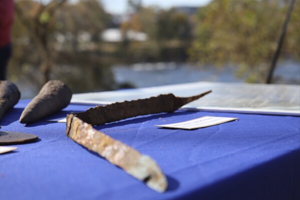 A Confederate sword blade is displayed at a press conference celebrating the early completion of the Congaree River cleanup on Monday, Nov. 13, 2023 in Columbia, S.C. Hundreds of Civil War relics were unearthed during the $20 million project. (AP Photo/James Pollard)