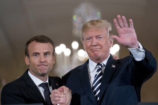 
              President Donald Trump and French President Emmanuel Macron embrace at the end of a news conference in the East Room of the White House in Washington, Tuesday, April 24, 2018. (AP Photo/Andrew Harnik)
            
