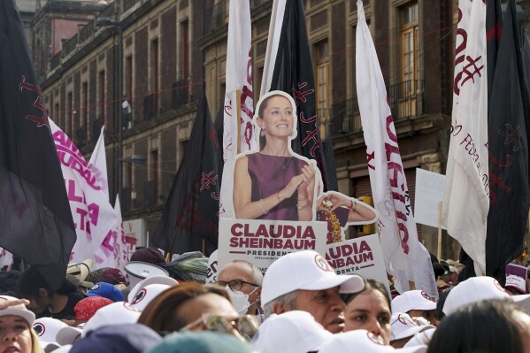 Supporters hold a cut of presidential candidate Claudia Sheinbaum during her opening campaign rally at the Zocalo in Mexico City, Friday, March 1, 2024. General elections are set for June 2. (AP Photo/Aurea Del Rosario)