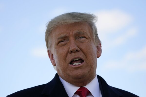 President Donald Trump speaks to reporters before a campaign rally at Green Bay Austin Straubel International Airport, Friday, Oct. 30, 2020, in Green Bay, Wis. (AP Photo/Alex Brandon)