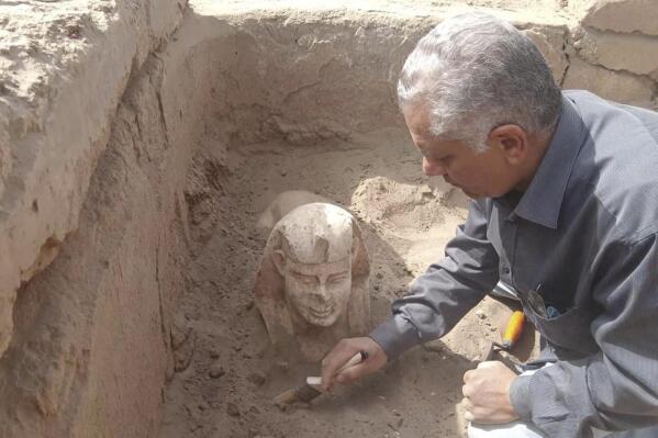 In this undated photo distributed Monday, March 6, 2023, by the Egyptian Ministry of Tourism and Antiquities, a sphinx statue believed to be made in the likeness of a Roman emperor is uncovered from an archaeological site in Qena, Egypt. The site that also contains a shrine to the Ancient Egyptian god Horus dating back to the Roman era, according to the country’s top antiquities official Mostafa Waziri. Waziri also said in a statement that initial examinations point to the statue being modeled after the Roman Emperor Claudius, who ruled in the first century AD. (Egyptian Ministry of Tourism and Antiquities via AP)