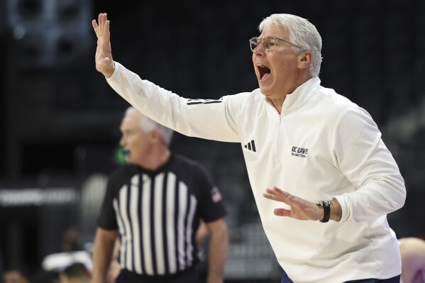 UC Davis head coach Jim Lee calls a play during the first half of an NCAA college basketball game against Long Beach State in the championship of the Big West Conference men's tournament Saturday, March 16, 2024, in Henderson, Nev. (AP Photo/Ronda Churchill)