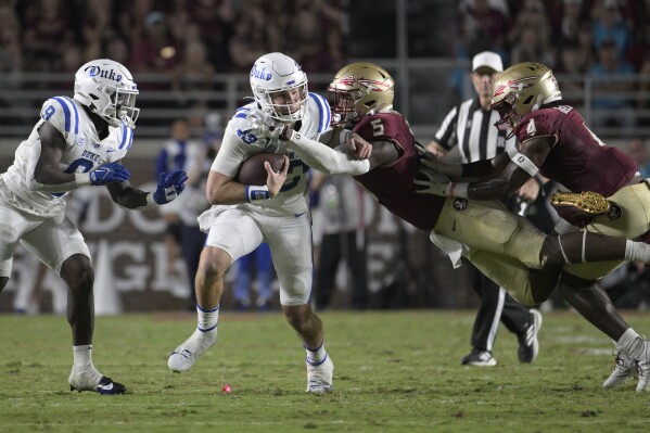 FILE - Duke quarterback Riley Leonard (13) is tackled by Florida State defensive lineman Jared Verse (5) after scrambling for yardage during the first half of an NCAA college football game, Saturday, Oct. 21, 2023, in Tallahassee, Fla. Verse is a possible first round pick in the NFL Draft. (AP Photo/Phelan M. Ebenhack, File)
