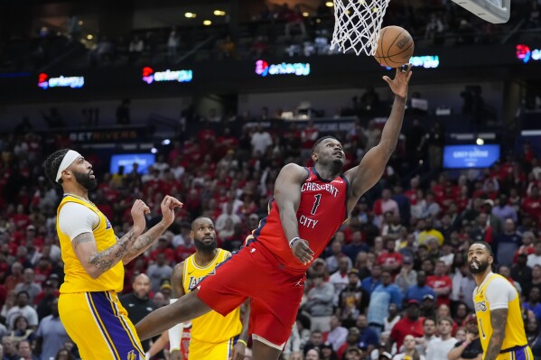 New Orleans Pelicans forward Zion Williamson (1) goes to the basket ahead of Los Angeles Lakers forward Anthony Davis in the second half of an NBA basketball play-in tournament game Tuesday, April 16, 2024, in New Orleans. The Lakers won 110-106. (AP Photo/Gerald Herbert)