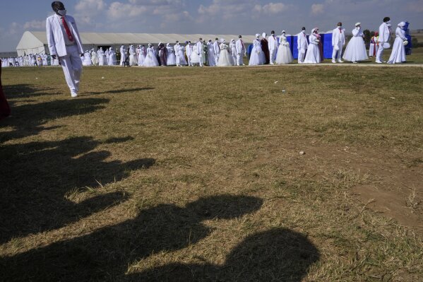 People queue during mass Easter weddings for 3,000 people, some polygamous, at the International Pentecost Holiness Church in Heidelberg, east of Johannesburg, South Africa, Sunday, April 20, 2025. (AP Photo/Themba Hadebe)