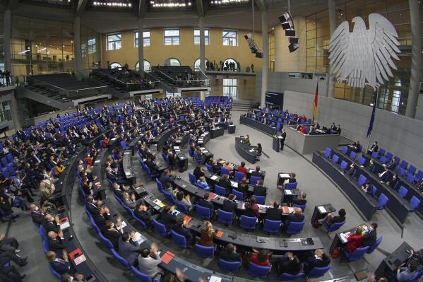 FILE - German Chancellor Olaf Scholz delivers a speech during a meeting of the German federal parliament, Bundestag, at the Reichstag building in Berlin, Germany, Dec. 15, 2021.Germany's parliament is expected to approve on Wednesday a resolution labeling as genocide Ukraine's "Holodomor" of the 1930s, a famine believed to have killed more than 3 million Ukrainians under the repressive rule of Soviet leader Josef Stalin. The resolution is being brought to the lower house, or Bundestag, by the three parties in Chancellor Olaf Scholz's governing coalition and the main opposition bloc. (AP Photo/Michael Sohn, File)