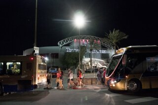 
              People load into buses destined to different Strip Casinos following a mass shooting at the Route 91 music festival along the Las Vegas Strip, Monday, Oct. 2, 2017. UNLV's Thomas & Mack Center was opened as a place of refuge. (Yasmina Chavez/Las Vegas Sun via AP)
            