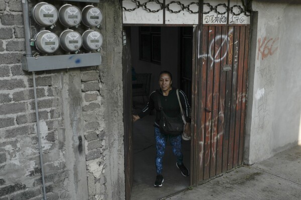 Domestic worker Concepcion Alejo walks out of her apartment as she heads to the gym before going to work, in Mexico City, Wednesday, April 24, 2024. Alejo is among approximately 2.5 million Mexicans — largely women — who serve as domestic workers in the Latin American nation. (AP Photo/Marco Ugarte)
