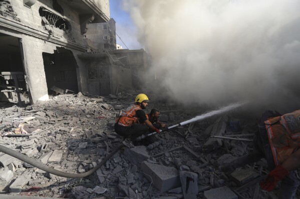 Palestinian firefighters extinguish a fire caused by an Israeli airstrike in Gaza City, Saturday, Nov. 4, 2023. (AP Photo/Abed Khaled)
