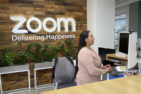 A woman works at Zoom headquarters on Friday, Feb. 3, 2023, in San Jose, Calif. Zoom is asking employees who live within a 50-mile radius of its offices to work onsite two days a week. (AP Photo/Haven Daley)