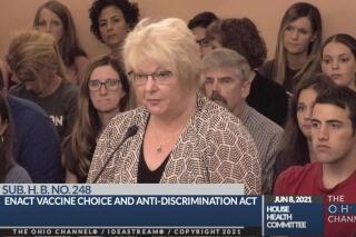 In this June 8, 2021, photo provided by the The Ohio Channel, Dr. Sherri Tenpenny speaks at a Ohio House Health Committee in Columbus, Ohio. The Cleveland-based osteopathic doctor testified that COVID-19 vaccines cause magnetism. “They can put a key on their forehead; it sticks,” said Tenpenny. (The Ohio Channel via AP)