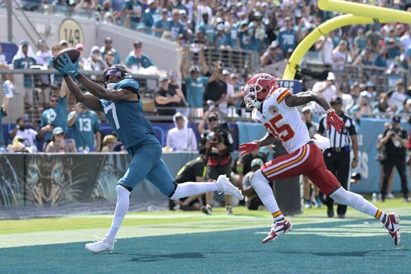 FILE - Jacksonville Jaguars wide receiver Zay Jones (7) catches a pass in front of Kansas City Chiefs cornerback Jaylen Watson (35), but can't get his second foot down inbounds to complete the reception, during the second half of an NFL football game, Sunday, Sept. 17, 2023, in Jacksonville, Fla. The Jacksonville Jaguars released veteran receiver Zay Jones on Tuesday, April 30, 2024, dumping him five days after drafting LSU's Brian Thomas Jr. with the 23rd overall pick and a day after agreeing to bring five-time Pro Bowler Jarvis Landry in for rookie minicamp. Jones was scheduled to count nearly $10.8 million against the salary cap in 2024, a significant payout for someone expected to be the team's fourth receiver at best. (AP Photo/Phelan M. Ebenhack, File)