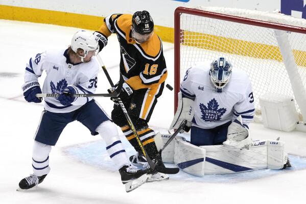 Pittsburgh Penguins' Jason Zucker (16) can't get his stick on the puck in front of Toronto Maple Leafs goaltender Matt Murray (30) with Maple Leafs' Rasmus Sandin (38) defending during the first period of an NHL hockey game in Pittsburgh, Tuesday, Nov. 15, 2022. (AP Photo/Gene J. Puskar)