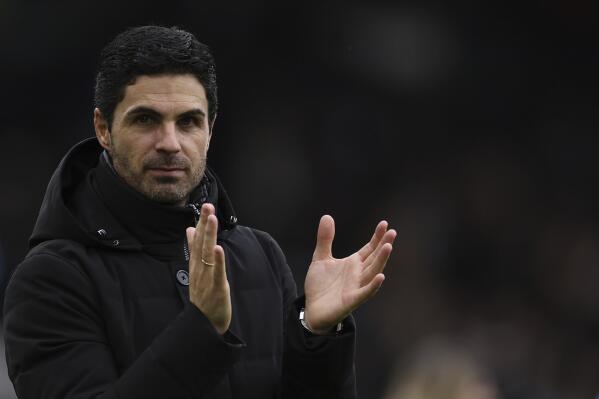 Arsenal's manager Mikel Arteta applauds at the end of the English Premier League soccer match between Fulham and Arsenal at Craven Cottage stadium in London, Sunday, March 12, 2023. (AP Photo/Ian Walton)