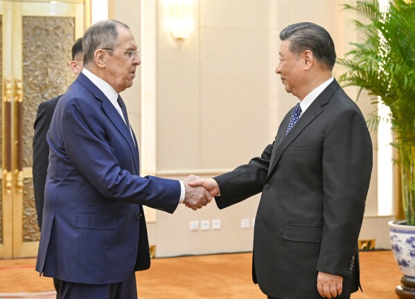 In this photo released by Xinhua News Agency, Russian Foreign Minister Sergey Lavrov, left, and Chinese President Xi Jinping meets at the Great Hall of the People in Beijing on Tuesday, April 9, 2024. Chinese leader Xi Jinping met with Russian Foreign Minister Sergey Lavrov Tuesday in a sign of mutual support and shared opposition to Western democracies amid Moscow's invasion of Ukraine. (Li Xueren/Xinhua via AP)