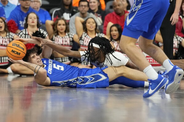 Creighton guard Francisco Farabello (5) passes from the floor against UNLV forward Keylan Boone (20) during the first half of an NCAA college basketball game Wednesday, Dec. 13, 2023, in Henderson, Nev. (AP Photo/John Locher)
