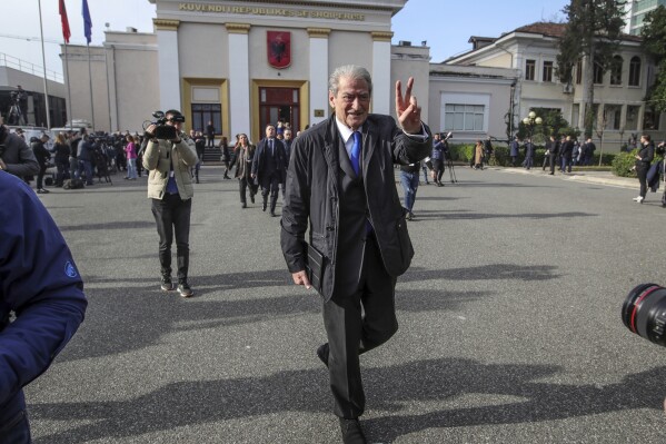 CORRECTS SECOND SENTENCE TO ''PROBED BY THE COUNTRY’S PROSECUTORS FOR POSSIBLE CORRUPTION'' - Sali Berisha leader of the opposition Democratic Party makes the V-sign as he leaves the parliament in Tirana, Albania, Thursday, Dec. 21, 2023. Albania’s parliament has voted to lift the legal immunity of former Prime Minister Sali Berisha, who leads the opposition Democratic Party and is being probed by the country’s prosecutors for possible corruption. (AP Photo/Armando Babani)