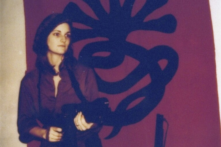 FILE - This poster issued by the Symbionese Liberation Army shows Patricia “Patty” Hearst, as "Tania", holding a machine gun. The newspaper heiress was kidnapped at gunpoint on Feb. 4, 1974, by the little-known armed revolutionary group. The 19-year-old college student's infamous abduction in Berkeley, Cali., led to Hearst joining forces with her captors for a 1974 bank robbery that earned her a prison sentence. Hearst, granddaughter of wealthy newspaper magnate William Randolph Hearst, will turn 70 on Feb. 20. (AP Photo/File)