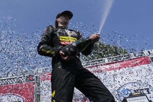 Colton Herta, of the United States, celebrates with his team after winning an IndyCar auto race in Toronto, Sunday, July 21, 2024. (Frank Gunn/The Canadian Press via ĢӰԺ)