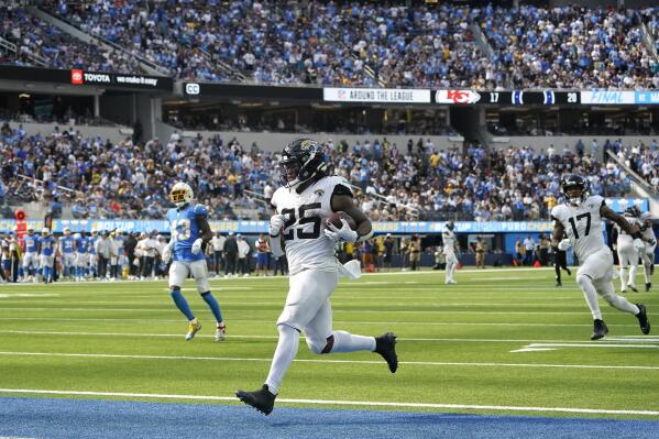 Jacksonville Jaguars running back James Robinson (25) runs the ball for a  touchdown during the first half of an NFL football game against the  Indianapolis Colts, Sunday, Sept. 18, 2022, in Jacksonville