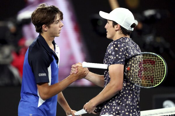 France's Harold Mayot, right, is congratulated by compatriot Arthur Cazaux after winning the junior boys final against at the Australian Open tennis championship in Melbourne, Australia, Saturday, Feb. 1, 2020. (AP Photo/Dita Alangkara)