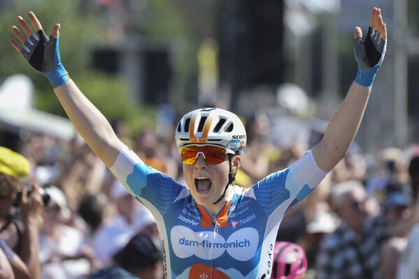 Charlotte Kool of The Netherlands celebrates as she crosses the finish line of the first stage of the Tour de France Women cycling race with start in Rotterdam and finish in The Hague, Netherlands, Monday, Aug. 12, 2024. (AP Photo/Peter Dejong)