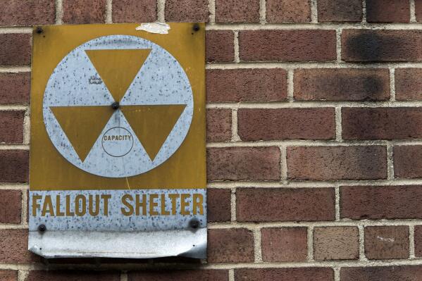 FILE - A fallout shelter sign hangs on a building on East 9th Street in New York, Jan. 16, 2018. According to a new poll from The Associated Press-NORC Center for Public Affairs Research, close to half of Americans say they are very concerned Russia would directly target the U.S. with nuclear weapons, and 3 in 10 are somewhat concerned about that. (AP Photo/Mary Altaffer, File)