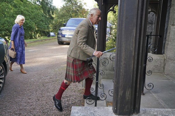 Britain's King Charles III, and Queen Camilla, background left, arrive at Crathie Parish Church for a church service to mark the first anniversary of the death of Queen Elizabeth II, near Balmoral, Scotland, Friday, Sept. 8, 2023. (Andrew Milligan/Pool Photo via AP)