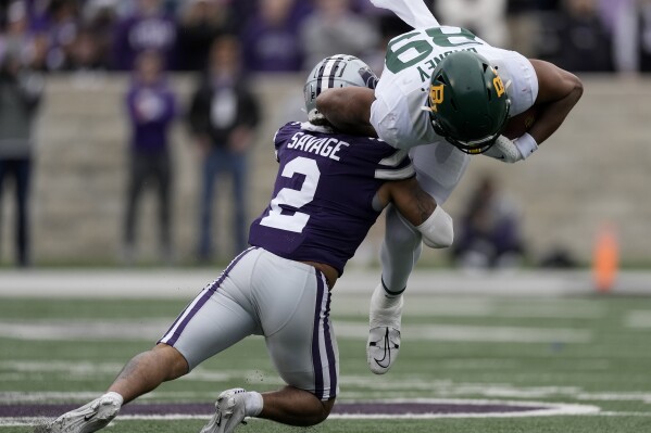 Baylor tight end Drake Dabney (89) is tackled by Kansas State safety Kobe Savage (2) during the first half of an NCAA college football game Saturday, Nov. 11, 2023, in Manhattan, Kan. (AP Photo/Charlie Riedel)