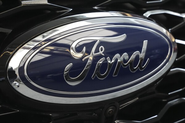 FILE - The Ford logo is seen on the grill of a Ford Explorer on display at the Pittsburgh International Auto Show in Pittsburgh, on Feb. 15, 2024. Two fatal crashes involving Ford’s Blue Cruise partially automated driving system have drawn the attention of U.S. auto safety regulators. (AP Photo/Gene J. Puskar, File)