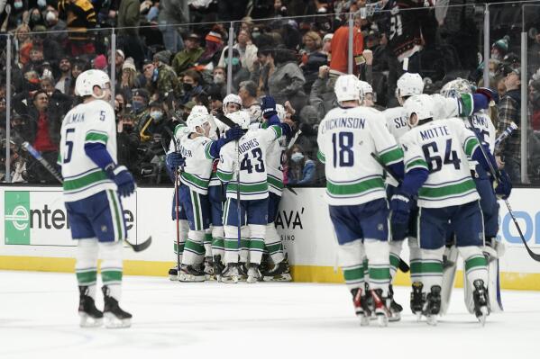 Vancouver Canucks celebrate the team's 2-1 overtime win against the Anaheim Ducks in an NHL hockey game Wednesday, Dec. 29, 2021, in Anaheim, Calif. (AP Photo/Jae C. Hong)