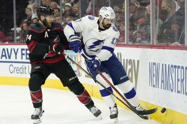 Carolina Hurricanes defenseman Jaccob Slavin (74) and Tampa Bay Lightning left wing Alex Killorn (17) chase the puck during the first period in Game 5 of an NHL hockey Stanley Cup second-round playoff series in Raleigh, N.C., Tuesday, June 8, 2021. (AP Photo/Gerry Broome)