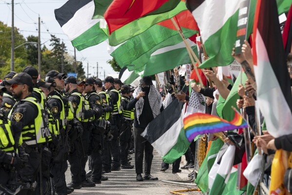Pro-Palestinian protesters gather along the route of the United Jewish Appeal's annual Walk With Israel march in Toronto, Canada, on Sunday, May 25, 2025. (Arlyn McAdorey/The Canadian Press via AP)
