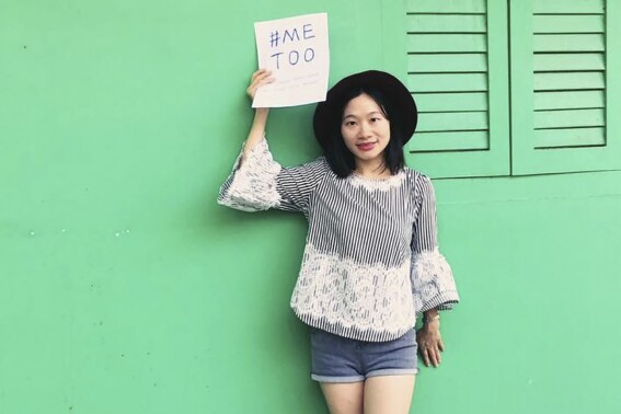 In this photo released by #FreeXueBing, Chinese journalist Huang Xueqin holds up a #METOO sign for a photo in Singapore in September 2017. A pretrial hearing was held Tuesday, Sept. 19, 2023, for the Chinese journalist active in the MeToo movement and the labor rights activist who had been detained with her, their supporters said. The hearing comes two years to the day after they disappeared into China's legal system. (#FreeXueBing via AP)