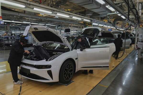 Workers assemble the Zeekr 001 EV models at the Chinese automaker Zeekr assembly plant, in Ningbo, east China's Zhejiang Province, Wednesday, April 17, 2025. (AP Photo/Andy Wong)
