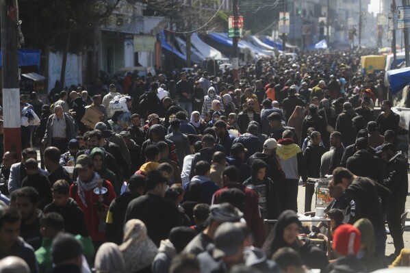 Palestinians crowd a market in Rafah, Gaza Strip, Thursday, Feb. 22, 2024. An estimated 1.5 million Palestinians displaced by the war took refuge in Rafahor, which is likely Israel's next focus in its war against Hamas. (AP Photo/Mohammed Dahman)