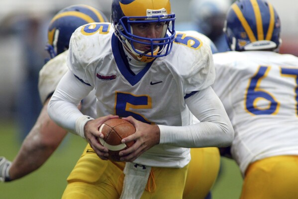 FILE -Delaware quarterback Joe Flacco (5) looks to hand off during a college football game against Rhode Island in South Kingstown, R.I. on Saturday, Sept. 23, 2006. Conference USA is finalizing a plan to add Delaware in 2025, the league’s latest expansion with a school moving up from Division I college football’s second tier to the Bowl Subdivision, a person with direct knowledge of the situation told The Associated Press on Monday. (AP Photo/Joe Giblin, File)