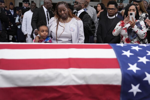 Chantemekki Fortson the mother of slain airman Roger Fortson, right, along with family watch Fortson's casket as they leave for a cemetery during his funeral at New Birth Missionary Baptist Church, Friday, May 17, 2024, in Stonecrest, Ga. (Ǻ Photo/Brynn Anderson)