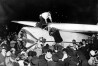 Wiley Post climbs out of the cockpit of his Lockheed Vega monoplane, Winnie Mae, after completing the first solo flight around the world at Floyd Bennet Field, Long Island, N.Y., midnight, July 22, 1933.  Wiley set a new record with the distance of 15,596 miles, 25,099 kilometer, in 7 days, 18 hours, 49 minutes.  (ĢӰԺ Photo)
