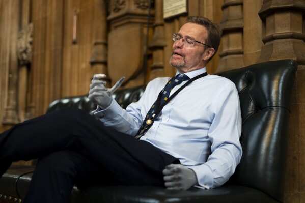 Conservative legislator Craig Mackinlay speaks during an interview in the Central Lobby of the Palace of Westminster, London, Wednesday May 22, 2024. Mackinlay returned to work six months after sepsis put him in a coma and forced the amputation of his hands and feet. (Jordan Pettitt/PA via AP)