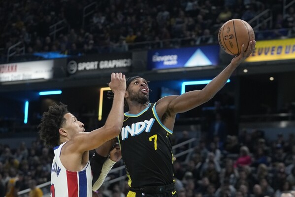 Indiana Pacers' Buddy Hield (7) shoots against Detroit Pistons' Cade Cunningham, left, during the first half of an NBA basketball In-Season Tournament game Friday, Nov. 24, 2023, in Indianapolis. (AP Photo/Darron Cummings)